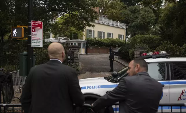 Police officers stand outside Gracie Mansion, the official residence of New York City Mayor Eric Adams, Thursday, Sep. 26, 2024, in New York. (AP Photo/Yuki Iwamura)