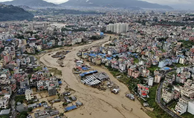 In this aerial image of the Kathmandu valley, Bagmati River is seen flooded due to heavy rains in Kathmandu, Nepal, Saturday, Sept. 28, 2024. (AP Photo/Gopen Rai)