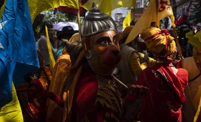 A holy man dressed as a Hanuman, Hindu god, participates in a protest against secularism, demanding the reinstatement of Nepal as a Hindu state and the restoration of the monarchy near parliament building in Kathmandu, Nepal, Friday, Sept. 13, 2024. (AP Photo/Niranjan Shrestha)