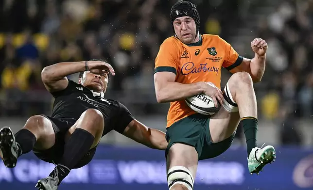 Australia's Nick Frost, right, and New Zealand's Caleb Clarke collide as they compete for the ball during their Rugby Championship match between the All Blacks and the Wallabies in Wellington, New Zealand, Saturday, Sept. 28, 2024.(Andrew Cornaga/Photosport via AP)