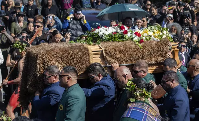 The coffin with the body of New Zealand's Maori King, Kiingi Tuheitia Pootatau Te Wherowhero VII, is carried up Taupiri Mountain for burial in Ngaruawahia, New Zealand, Thursday, Sept. 5, 2024. (AP Photo/Alan Gibson)