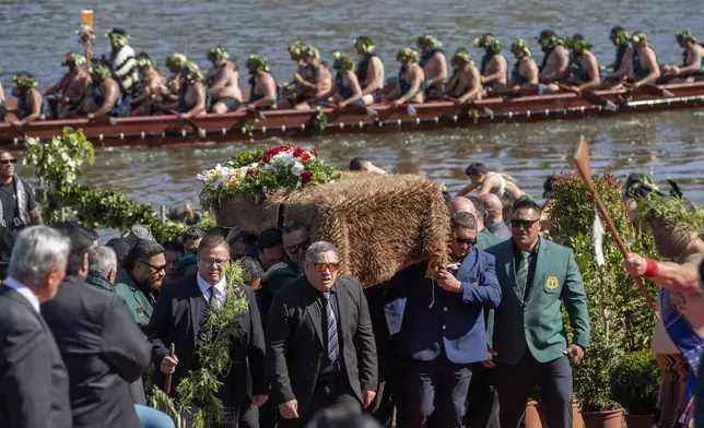 The coffin with the body of New Zealand's Maori King, Kiingi Tuheitia Pootatau Te Wherowhero VII, is carried after being transported on a waka (a traditional canoe) for burial in Ngaruawahia, New Zealand, Thursday, Sept. 5, 2024. (AP Photo/Alan Gibson)