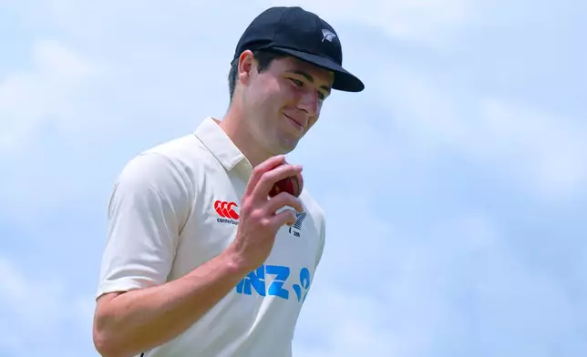 New Zealand's William O'Rourke shows the ball in his hand as he celebrates his 5-wicket haul at the end of the Sri Lanka innings on the second day of the first cricket test match between New Zealand and Sri Lanka in Galle, Sri Lanka, Thursday, Sept. 19, 2024. (AP Photo/Viraj Kothalawala)