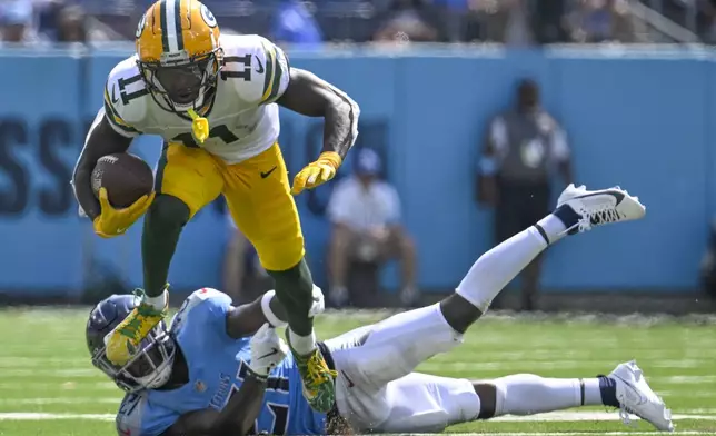 Green Bay Packers' Jayden Reed tries to get past Tennessee Titans' Roger McCreary after a catch during the second half of an NFL football game Sunday, Sept. 22, 2024, in Nashville, Tenn. (AP Photo/John Amis)