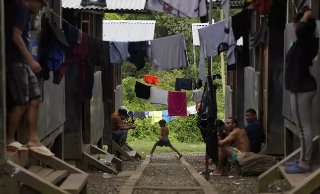 Migrants rest at a camp after treking across the Darien Gap from Colombia in hopes of reaching the U.S., in Lajas Blancas, Panama, Thursday, Sept. 26, 2024. (AP Photo/Matias Delacroix)