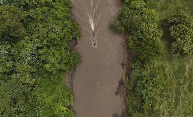 A boat takes migrants to Lajas Blanca, Panama, Thursday, Sept. 26, 2024, after the migrants trekked across the Darien Gap from Colombia in hopes of reaching the U.S. (AP Photo/Matias Delacroix)