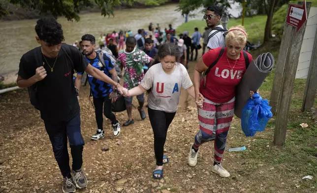 Migrants arrive to Lajas Blancas, Panama, after trekking across the Darien Gap from Colombia in hopes of reaching the U.S., Thursday, Sept. 26, 2024. (AP Photo/Matias Delacroix)