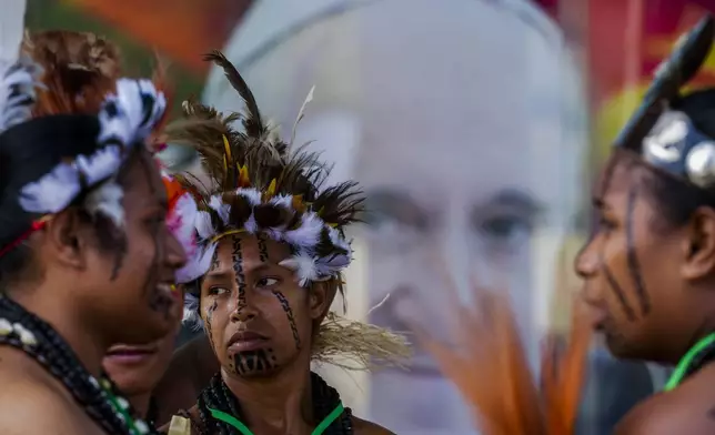 Performers in traditional Papuasian dress wait for Pope Francis to arrive outside the APEC Haus in Port Moresby, Saturday, Sept. 7, 2024. (AP Photo/Gregorio Borgia)