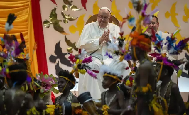 Pope Francis attends a traditional dance performed by the Caritas Technical Secondary School pupils in Port Moresby on Saturday, Sept. 7, 2024. As a second leg of his 11-day trip to Asia and Oceania Pope Francis's visit to Papua New Guinea will take him to a remote part of the South Pacific island nation where Christianity is a recent addition to traditional spiritual beliefs developed over millennia. (AP Photo/Gregorio Borgia)