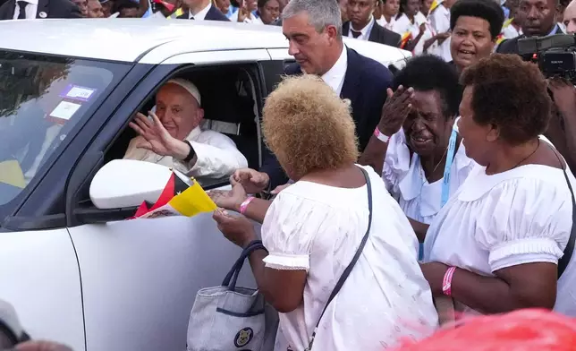 Pope Francis waves as he leaves Caritas Technical Secondary School in Port Moresby, Papua New Guinea, Saturday, Sept. 7, 2024. (AP Photo/Mark Baker)