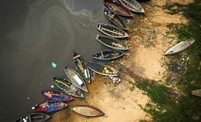 Fishing boats sit on the shore of the Paraguay River in Mariano Roque Alonso, Paraguay, Monday, Sept. 9, 2024. Water levels have plunged to their lowest-ever level amid a drought, according to Paraguay's Meteorology and Hydrology Office. (AP Photo/Jorge Saenz)