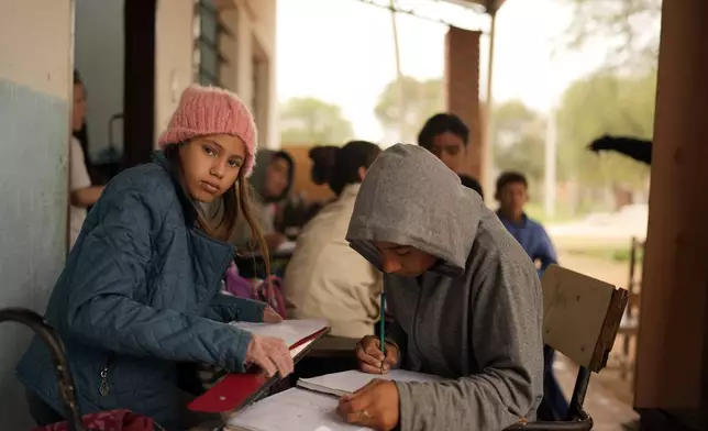 Eighth graders take notes during a geography class at the Nueva Asuncion public school in Chaco-i, Paraguay, Tuesday, Aug. 20, 2024. Paraguay seeks to roll out its first national sex-ed curriculum in September 2024. (AP Photo/Jorge Saenz)