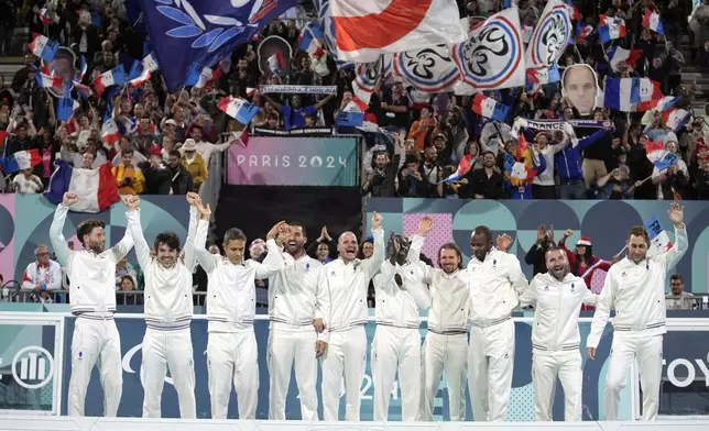 France players celebrate winning the blind football gold medal match at the 2024 Paralympics, Saturday, Sept. 7, 2024, in Paris, France. (AP Photo/Christophe Ena)