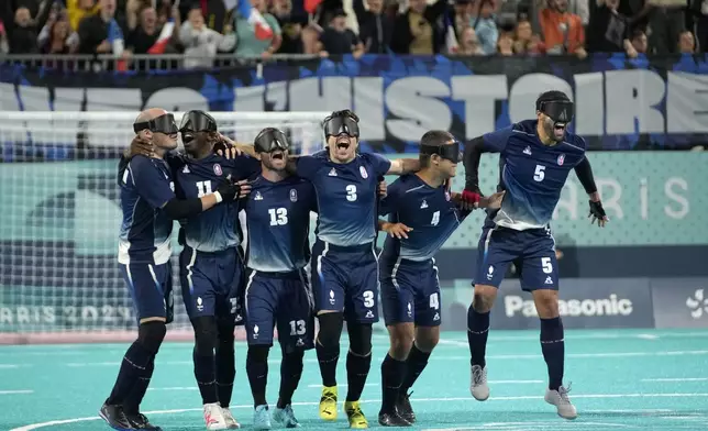 France players celebrate winning the blind football gold medal match at the 2024 Paralympics, Saturday, Sept. 7, 2024, in Paris, France. (AP Photo/Christophe Ena)