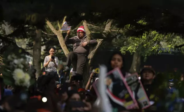 People attend the funeral of former President Alberto Fujimori n Lima, Peru, Saturday, Sept. 14, 2024. (AP Photo/Guadalupe Pardo)