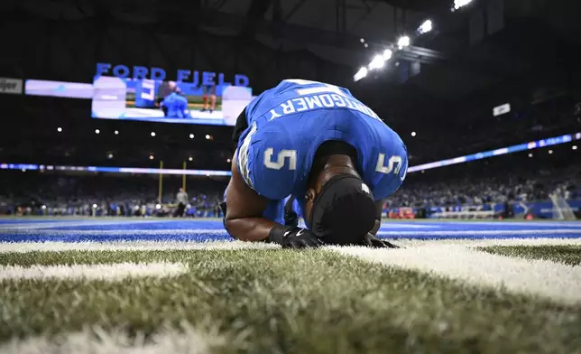 Detroit Lions running back David Montgomery (5) takes a moment after scoring a one-yard touchdown run against the Los Angeles Rams during overtime in an NFL football game in Detroit, Sunday, Sept. 8, 2024. (AP Photo/David Dermer)