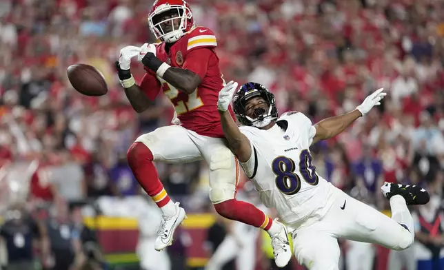 Kansas City Chiefs defensive back Chamarri Conner (27) is unable to intercept a pass intended for Baltimore Ravens tight end Isaiah Likely during the second half of an NFL football game Thursday, Sept. 5, 2024, in Kansas City, Mo. (AP Photo/Ed Zurga)