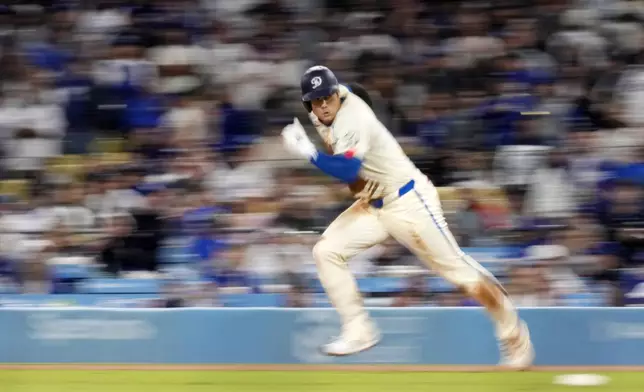 Los Angeles Dodgers' Shohei Ohtani runs from first on his way to stealing second during the ninth inning of a baseball game against the Colorado Rockies, Saturday, Sept. 21, 2024, in Los Angeles. (AP Photo/Mark J. Terrill)