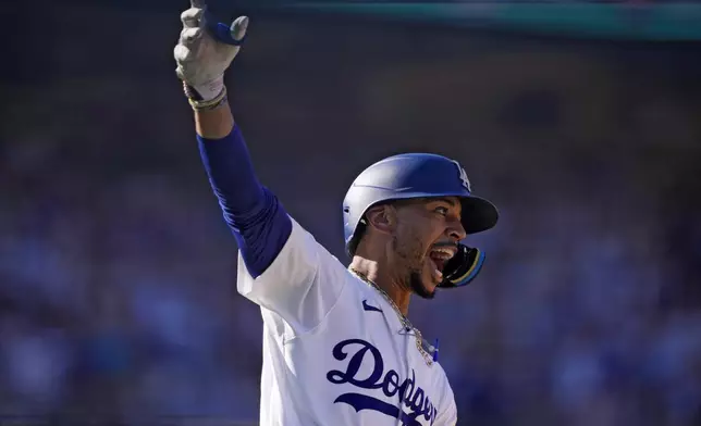 Los Angeles Dodgers' Mookie Betts celebrates after hitting a walk-off solo home run during the ninth inning of a baseball game against the Colorado Rockies, Sunday, Sept. 22, 2024, in Los Angeles. The Dodgers won 6-5. (AP Photo/Mark J. Terrill)