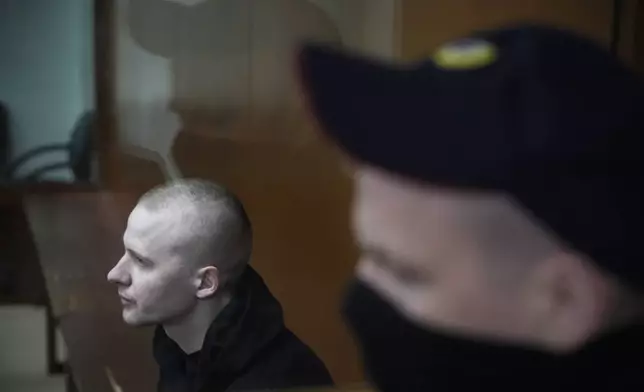 Alexander Permyakov, a Ukrainian national standing trial over a car bombing that injured well-known nationalist novelist and ardent Kremlin supporter Zakhar Prilepin, sits in a glass cage in a courtroom prior to a session in the Russian Military Court in Moscow, Russia, Monday, Sept. 30, 2024. (AP Photo/Alexander Zemlianichenko)