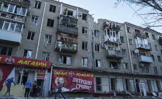 People clear the rubble in a front of a residential building heavily damaged after a Russian airstrike in Kramatorsk, Donetsk region, Ukraine, Wednesday, Sept. 25, 2024. (AP Photo/Evgeniy Maloletka)Photo/Evgeniy Maloletka)