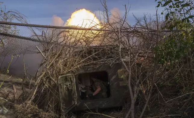 Ukrainian serviceman of 56th brigade fire by self-propelled artillery towards Russian positions at the frontline on Chasiv Yar direction, Donetsk region, Ukraine, Sept. 27, 2024. (AP Photo/Evgeniy Maloletka)