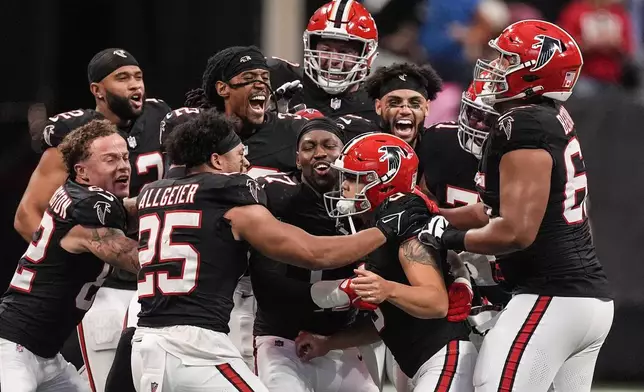 Atlanta Falcons players celebrate place kicker Younghoe Koo's game-winning 58-yard-field goal against the New Orleans Saints during the second half of an NFL football game, Sunday, Sept. 29, 2024, in Atlanta. (AP Photo/John Bazemore)