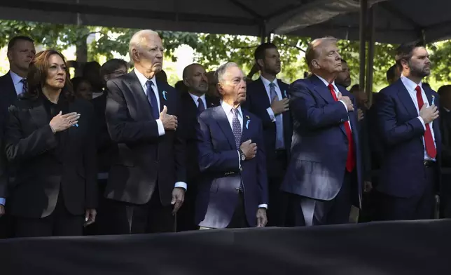 From left, Democratic presidential nominee Vice President Kamala Harris, President Joe Biden, Michael Bloomberg, Republican presidential nominee former President Donald Trump and Republican vice presidential nominee Sen. JD Vance, R-Ohio, attend the 9/11 Memorial ceremony on the 23rd anniversary of the Sept. 11, 2001 terror attacks, Wednesday, Sept. 11, 2024, in New York. (AP Photo/Yuki Iwamura)