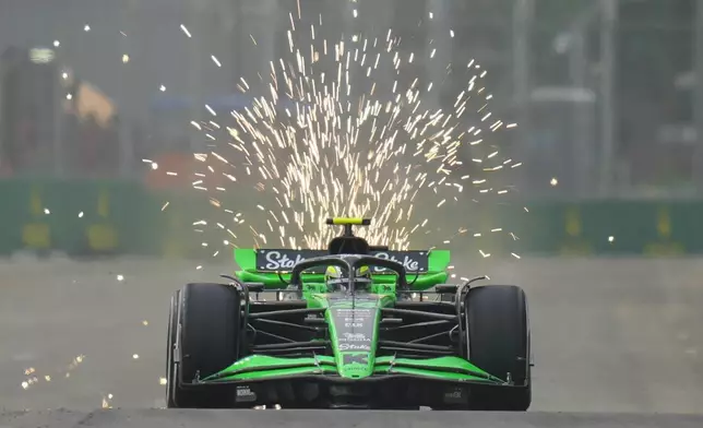 Kick Sauber driver Zhou Guanyu of China steers his car during the first practice session of the Singapore Formula One Grand Prix at the Marina Bay Street Circuit, in Singapore, Friday, Sept. 20, 2024. (AP Photo/Vincent Thian)