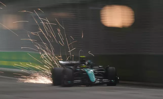 Mercedes driver Lewis Hamilton of Britain steers his car during the qualifying session of the Singapore Formula One Grand Prix at the Marina Bay Street Circuit, in Singapore, Saturday, Sept. 21, 2024. (AP Photo/Vincent Thian)