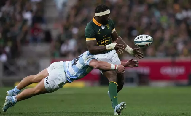 South Africa's captain Siya Kolisi, right, is tackled by Argentina's Rodrigo Isgro during a rugby championship test match at Mbombela stadium in Nelspruit, South Africa, Saturday, Sept. 28, 2024. (AP Photo/Themba Hadebe)