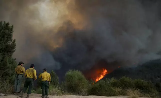 Fire crews monitor the Line Fire, Saturday, Sept. 7, 2024, in Running Springs, Calif. (AP Photo/Eric Thayer)