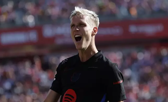 Barcelona's Dani Olmo celebrates after scoring his side's third goal during the Spanish La Liga soccer match between Girona and Barcelona at the Montilivi stadium in Girona, Spain, Sunday, Sept. 15, 2024. (AP Photo/Joan Monfort)