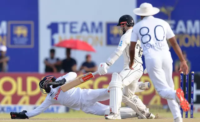 Sri Lanka's Kusal Mendis, left, dives to catch New Zealand's Kane Williamson out on the second day of the first cricket test match between New Zealand and Sri Lanka in Galle, Sri Lanka, Thursday, Sept. 19, 2024. (AP Photo/Viraj Kothalawala)