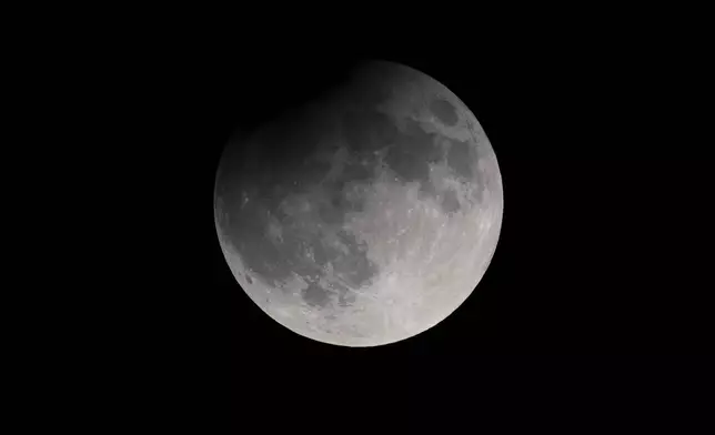 A partial eclipse darkens a rising supermoon Tuesday, Sept. 17, 2024, in Nashville, Tenn. (AP Photo/George Walker IV)