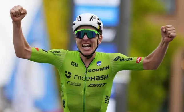 Slovenia's Tadej Pogacar crosses the finish line to win the Men Elite road race of the Cycling and Para-cycling Road World Championships in Zurich, Switzerland, Sunday, Sept. 29, 2024. (AP Photo/Peter Dejong)