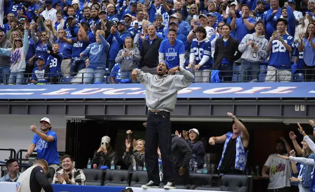 Indiana Pacers basketball player Tyrese Haliburton celebrates after Indianapolis Colts quarterback Anthony Richardson makes a touchdown run during the second half of an NFL football game against the Houston Texans, Sunday, Sept. 8, 2024, in Indianapolis. (AP Photo/Darron Cummings)