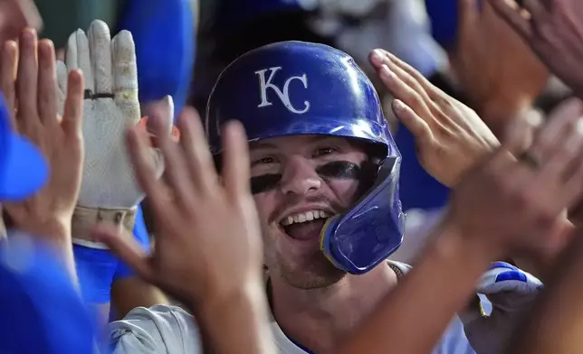 Kansas City Royals' Bobby Witt Jr. celebrates with teammates in the dugout after hitting a grand slam during the third inning of a baseball game against the Detroit Tigers Monday, Sept. 16, 2024, in Kansas City, Mo. (AP Photo/Charlie Riedel)