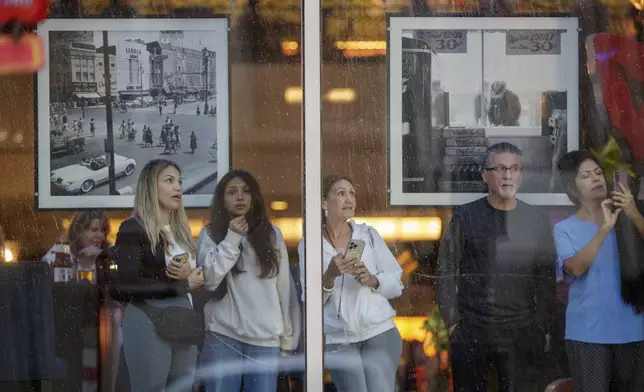 People watch Hurricane Francine from inside the Sheraton on Canal Street in New Orleans, Wednesday, Sept. 11, 2024. (David Grunfeld/The Times-Picayune/The New Orleans Advocate via AP)