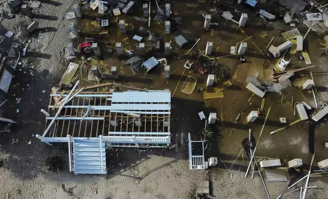 Foundations and steps to buildings that were destroyed by the storm surge from Hurricane Helene are seen along the shoreline in the aftermath of the storm, in Cedar Key, Fla., Friday, Sept. 27, 2024. (AP Photo/Stephen Smith)