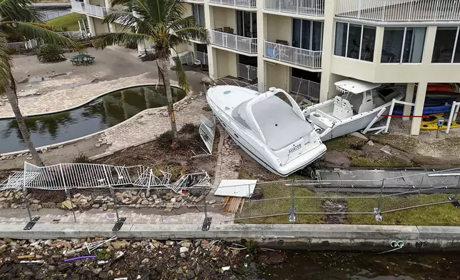 Boats sit after being pushed ashore by floodwaters from Hurricane Helene on Saturday, Sept. 28, 2024, in St. Petersburg, Fla. (AP Photo/Mike Carlson)