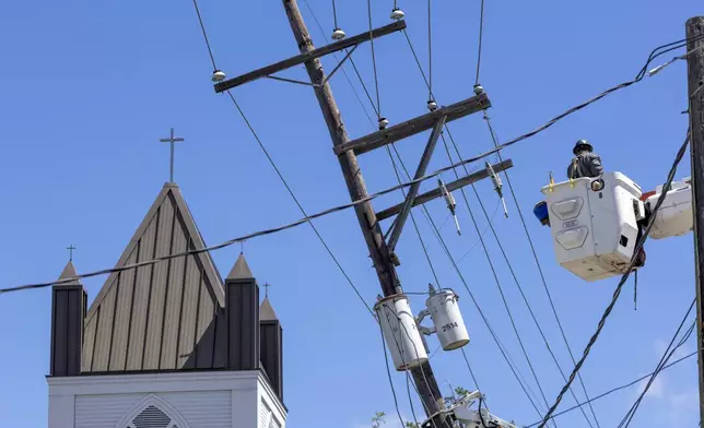 City of Tallahassee, Florida utility crews help straighten a utility pole s damaged by Hurricane Francine Thursday, Sept. 12, 2024, in downtown Houma, La. (Chris Granger/The Times-Picayune/The New Orleans Advocate via AP)