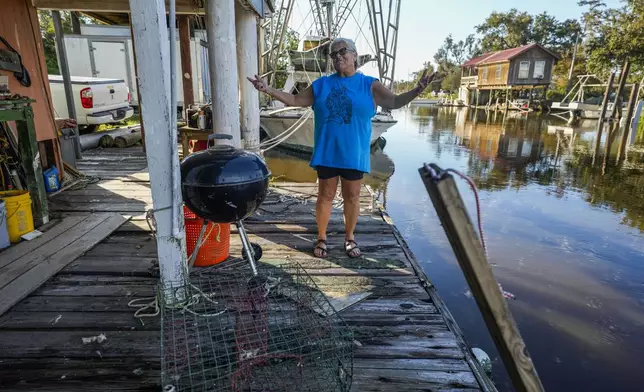 Debra Matherne describes her experience as she rode out Hurricane Francine the previous night, along Bayou Pointe-au-Chien, La., Thursday, Sept. 12, 2024. (AP Photo/Gerald Herbert)