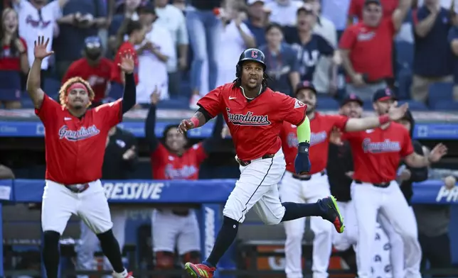 Cleveland Guardians' José Ramírez scores on a walk off RBI single hit by Andrés Giménez to defeat the Minnesota Twins 3-2 in 10 innings in a baseball game, Thursday, Sept. 19, 2024, in Cleveland. (AP Photo/Nick Cammett)