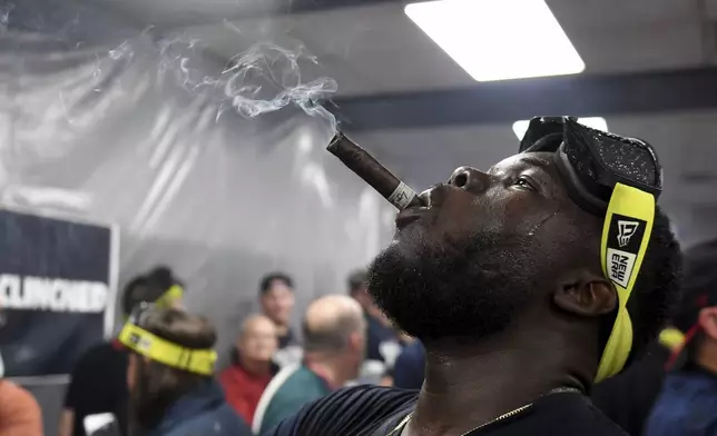 Cleveland Guardians' Jhonkensy Noel celebrates in the clubhouse after they defeated the Minnesota Twins to clinch a baseball playoff berth, Thursday, Sept. 19, 2024, in Cleveland. (AP Photo/Nick Cammett)