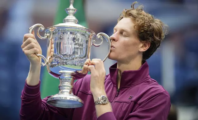 Jannik Sinner, of Italy, kisses the championship trophy after defeating Taylor Fritz, of the United States, in the men's singles final of the U.S. Open tennis championships, Sunday, Sept. 8, 2024, in New York. (AP Photo/Seth Wenig)