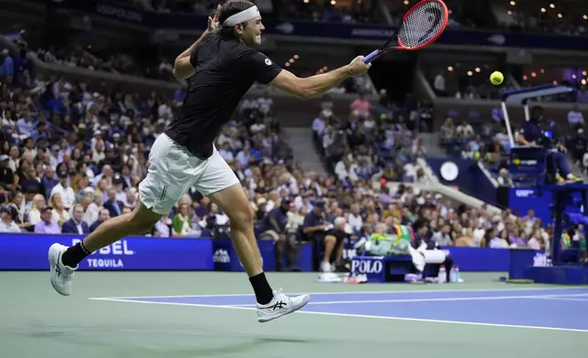 Taylor Fritz, of the United States, returns a shot to Frances Tiafoe, of the United States, during the men's singles semifinals of the U.S. Open tennis championships, Friday, Sept. 6, 2024, in New York. (AP Photo/Kirsty Wigglesworth)