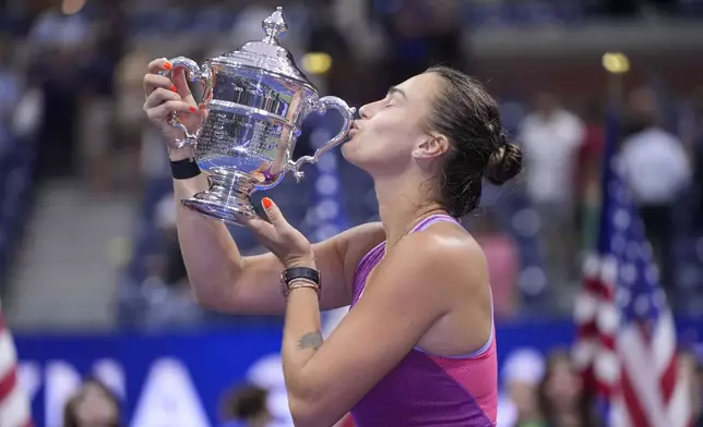 Aryna Sabalenka, of Belarus, kisses the trophy after winning the women's singles final of the U.S. Open tennis championships against Jessica Pegula, of the United States, , Saturday, Sept. 7, 2024, in New York. (AP Photo/Frank Franklin II)