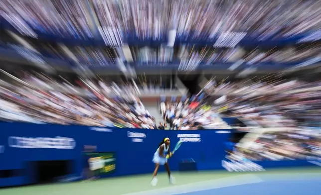 In this photo made using a zoom lens combined with a slow shutter speed shown is Coco Gauff, of the United States, as she waits to return a shot from Emma Navarro, of the United States, during the fourth round of the U.S. Open tennis championships, Sunday, Sept. 1, in New York. 2024. (AP Photo/Pamela Smith)