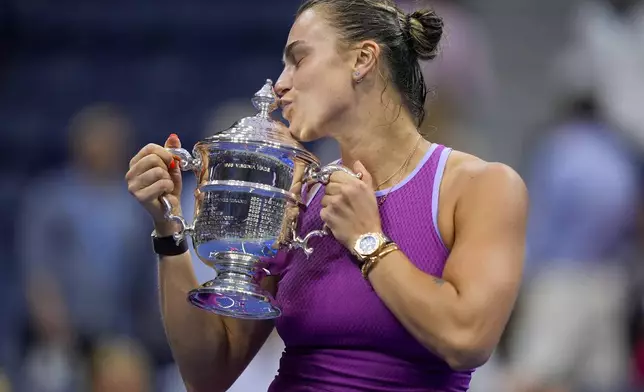 Aryna Sabalenka, of Belarus, kisses the championship trophy after defeating Jessica Pegula, of the United States, in the women's singles final of the U.S. Open tennis championships, Saturday, Sept. 7, 2024, in New York. (AP Photo/Julia Nikhinson)